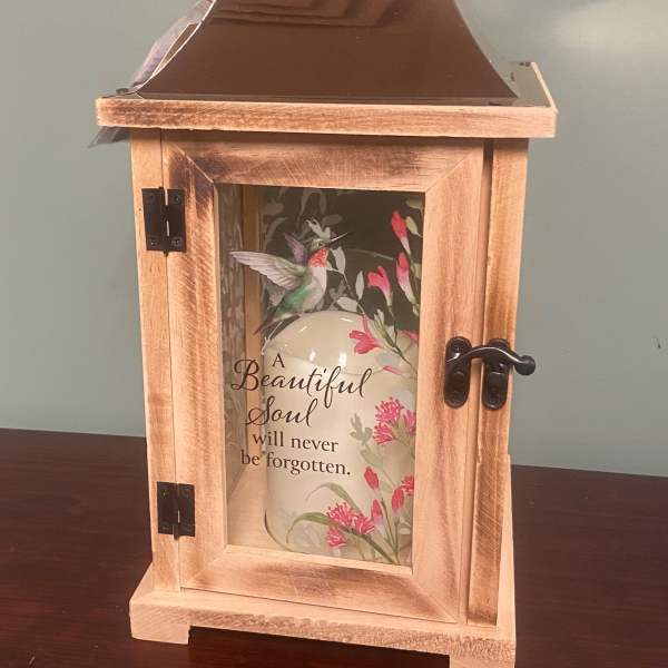 Wooden memorial lantern with a hummingbird design and a candle inside