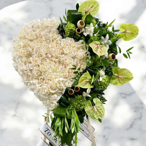 Heart-shaped bouquet of white roses with green anthuriums and orchids