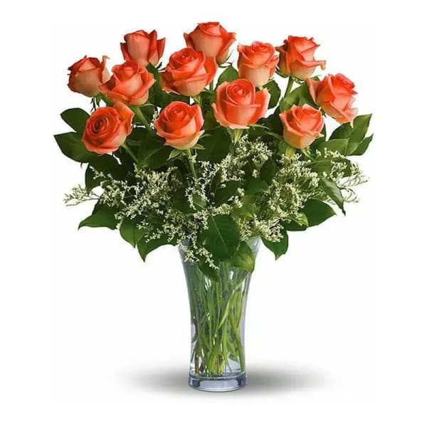 Orange roses arranged in a clear glass vase