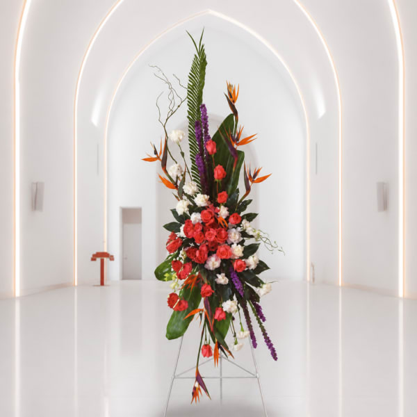 Tall tropical floral arrangement with red roses and orange bird-of-paradise