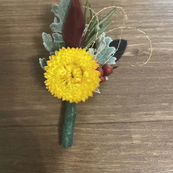 Yellow chrysanthemum boutonniere with berries and foliage