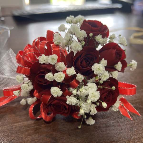 Small bouquet of red roses and white baby's breath with red ribbon
