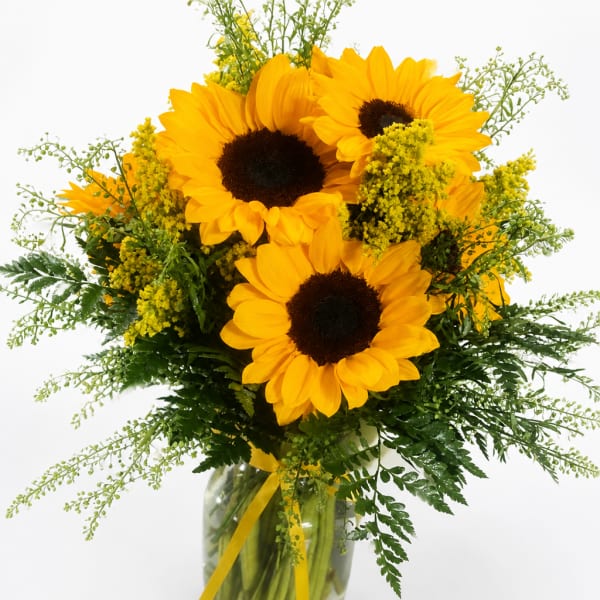 Bouquet of yellow sunflowers in a glass vase