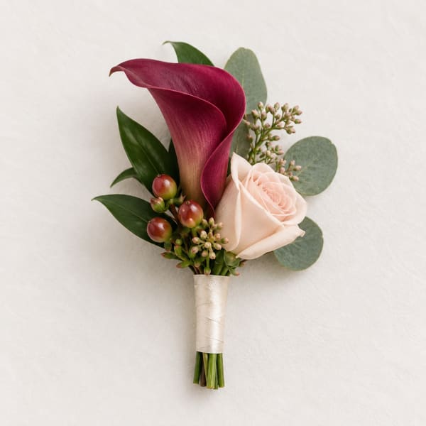 Boutonniere with burgundy calla lily and pale pink rose