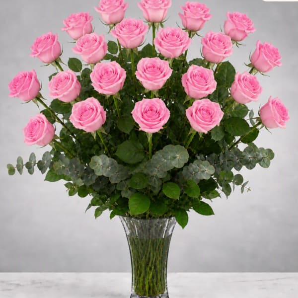 Tall bouquet of pink roses in a clear glass vase