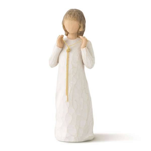 Carved faceless figurine in a long white dress holding a gold chain necklace with both hands