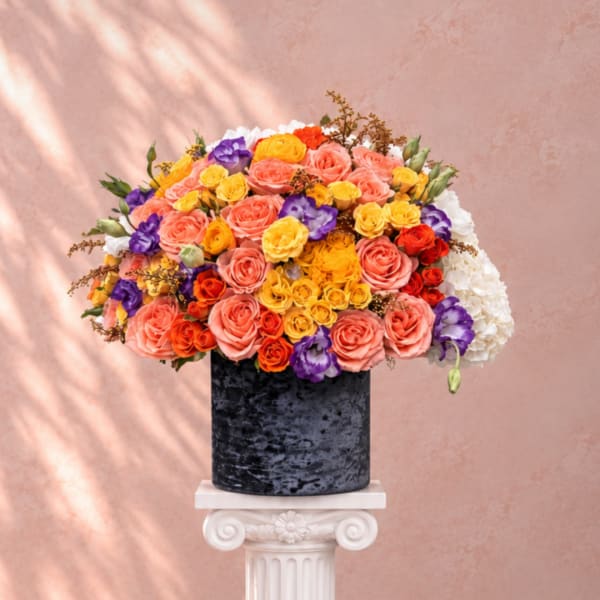 Colorful rose bouquet in a black cylindrical vase