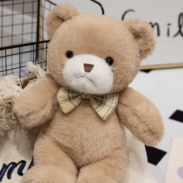 Plush teddy bear with a plaid bow tie
