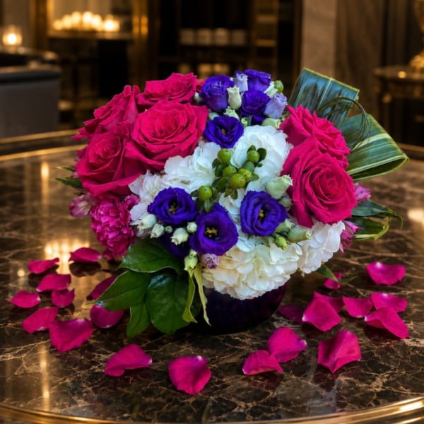 Bouquet of pink, purple, and white flowers in a dark vase
