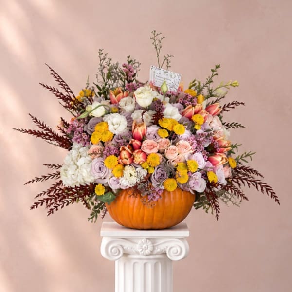 Mixed floral arrangement in a carved pumpkin container