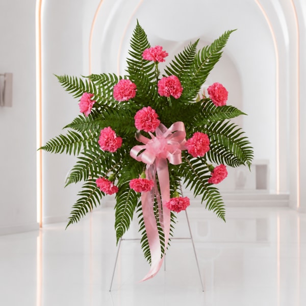 Pink carnation standing spray with a pink ribbon on a metal easel