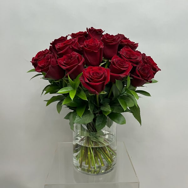 Bouquet of deep red roses in a clear glass vase