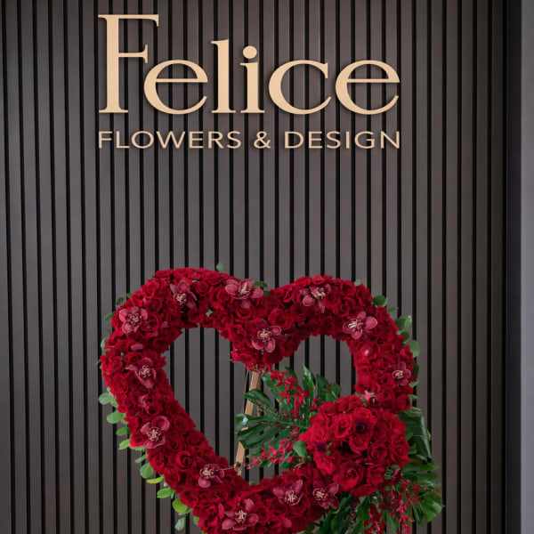 Heart-shaped red rose standing arrangement on an easel