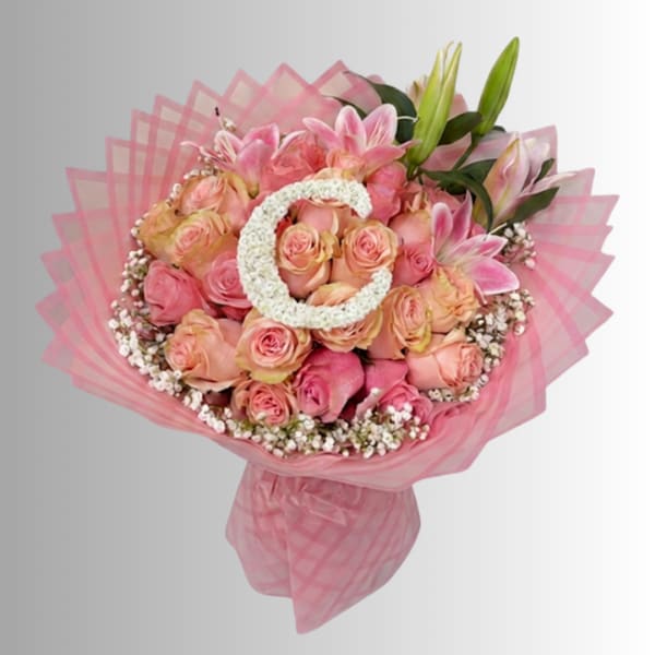 Pink and peach rose bouquet with lilies wrapped in pink mesh