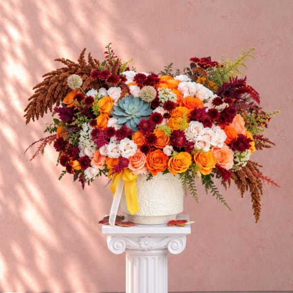 Large mixed bouquet of roses and mums in a white vase