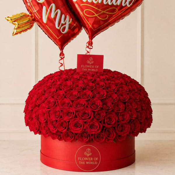 Round box of red roses with heart-shaped balloons above
