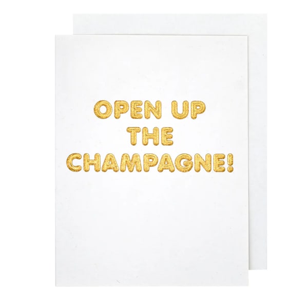 White card with gold text reading "OPEN UP THE CHAMPAGNE!"