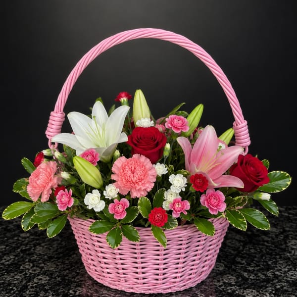 Pink basket of lilies, roses, and carnations