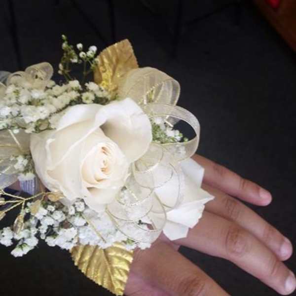 White rose wrist corsage with gold ribbon and baby's breath