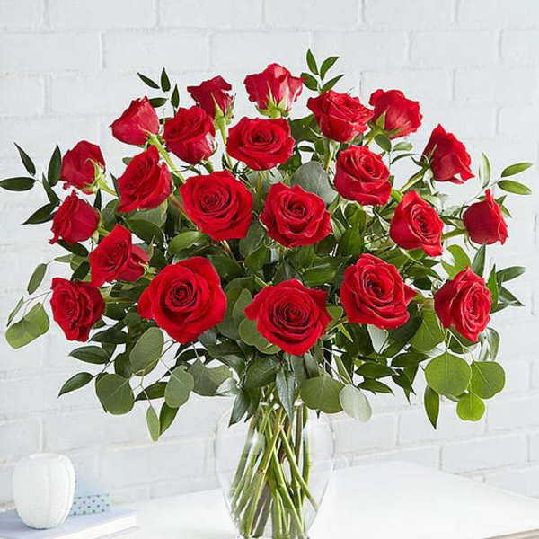 Red roses arranged in a clear glass vase
