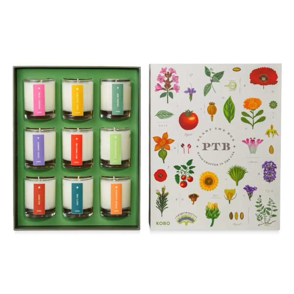 Set of nine scented candles in a gift box beside a floral-illustrated lid