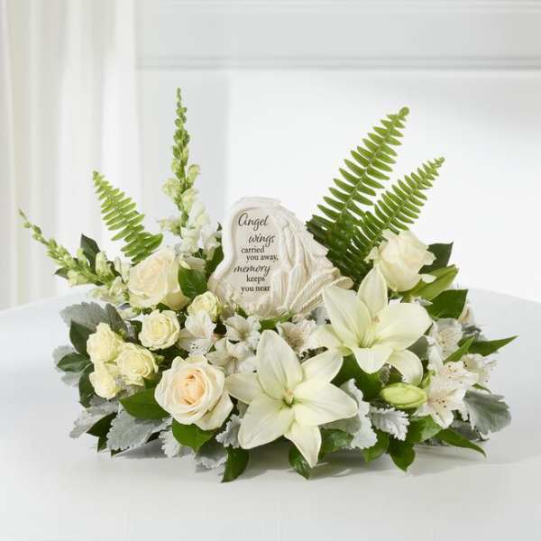 White floral sympathy arrangement with an angel memorial plaque