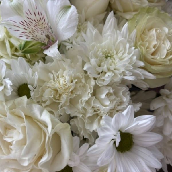 White bouquet with roses, daisies, and ruffled blooms