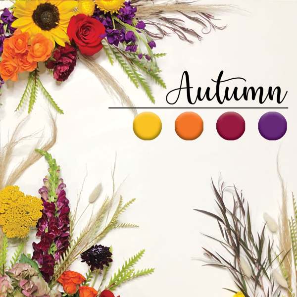 Autumn floral arrangement with sunflowers, roses, and purple blooms
