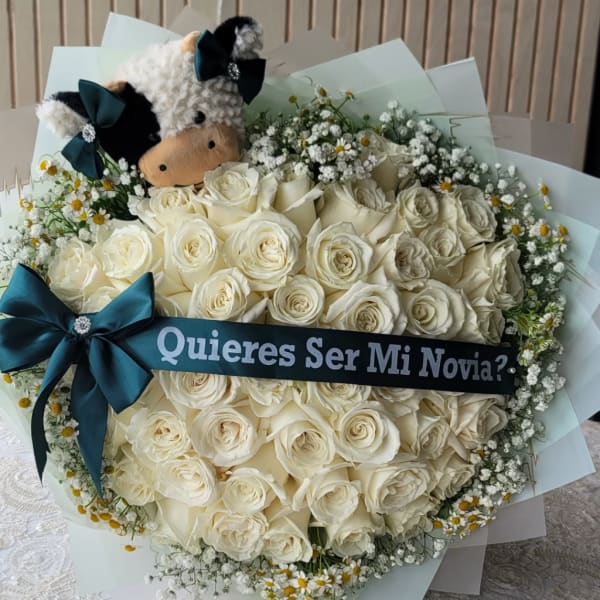 Bouquet of white roses with a plush cow and a proposal ribbon