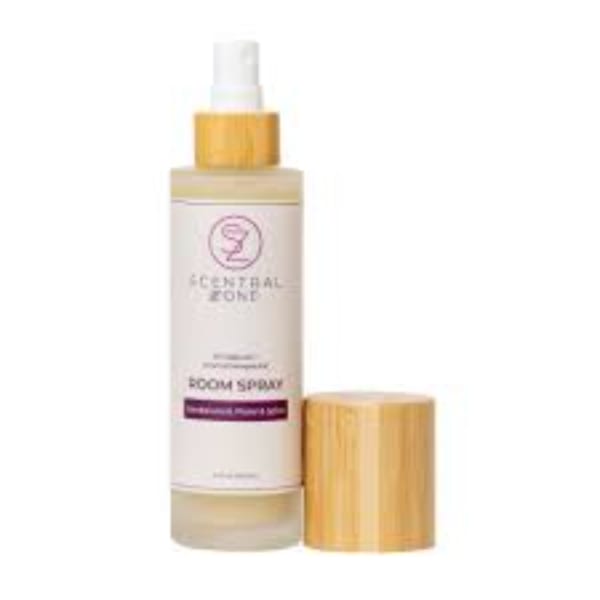 Bottle of bloom spray with a gold cap on a white background