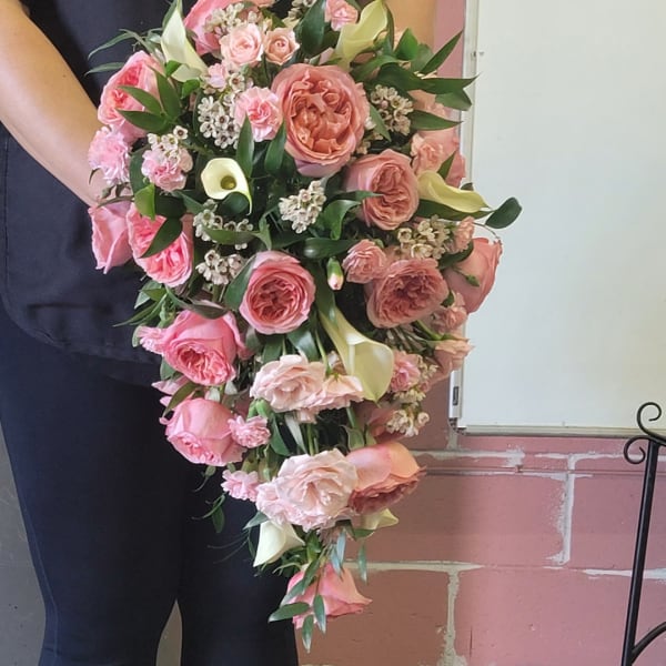 Large pink bouquet with roses, calla lilies, and greenery