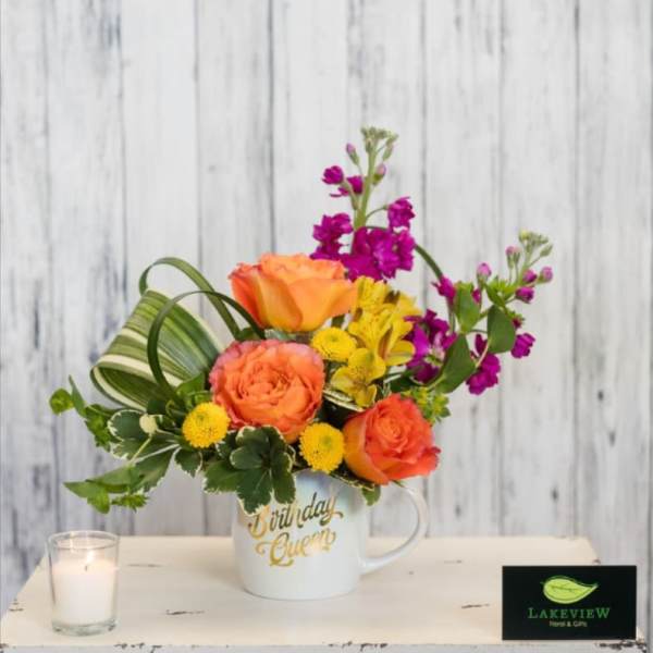 Colorful flower arrangement in a white mug with "Birthday Queen" text