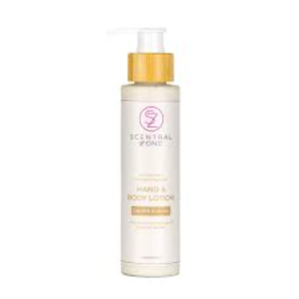 Bottle of Scentsy body lotion with a gold cap on a white background