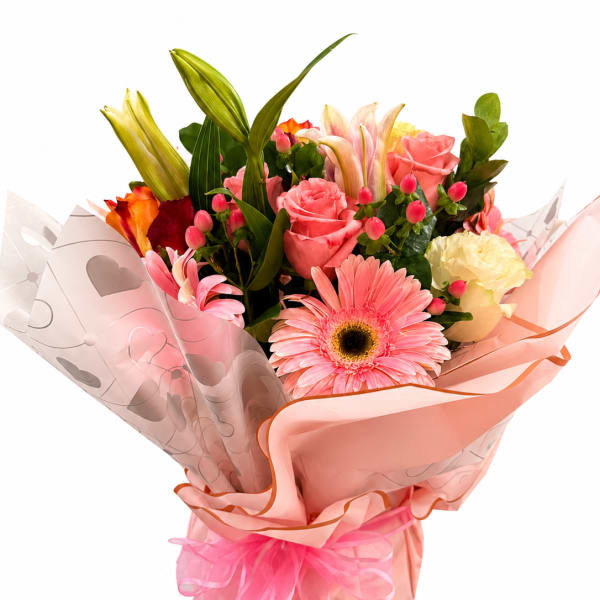 Pink and peach mixed bouquet with roses, lilies, and a gerbera daisy in pink wrap