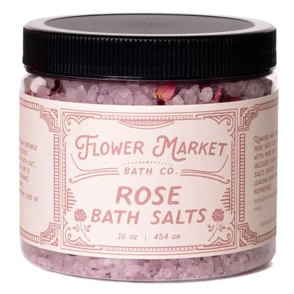 Jar of rose bath salts with a black lid and pink label