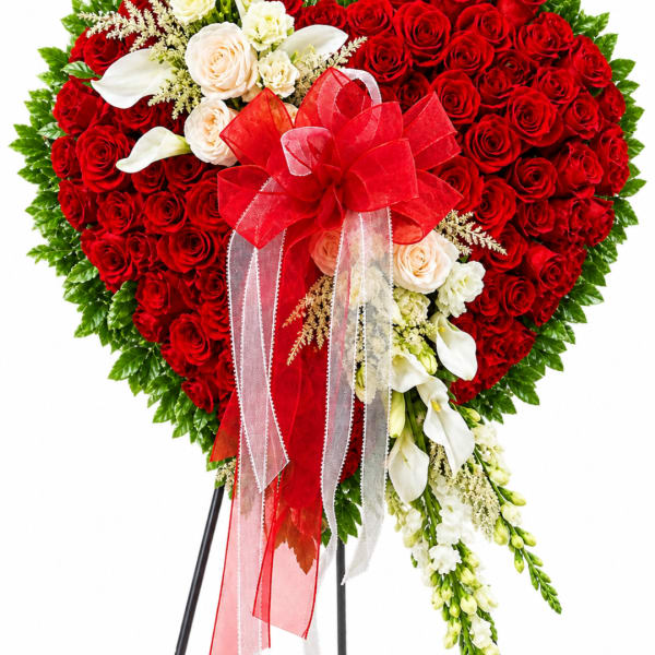 Heart-shaped red rose arrangement with white flowers and a red ribbon bow