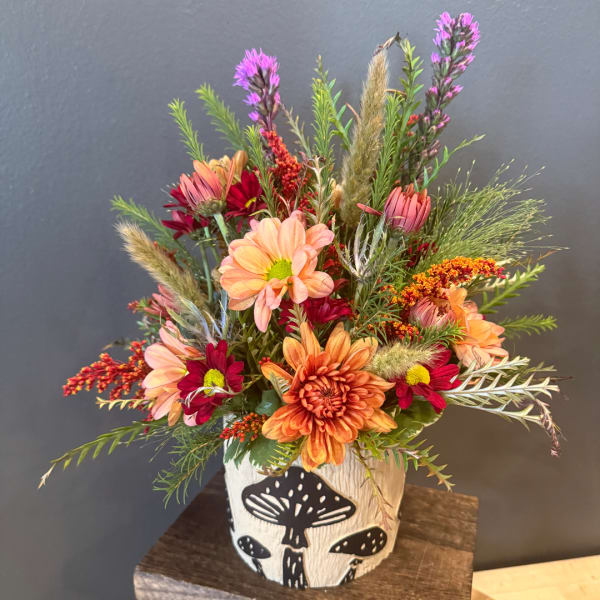 Mixed autumn bouquet in a white mushroom-shaped vase