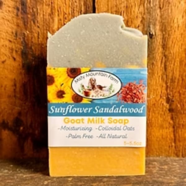 Bar of sunflower sandalwood goat milk soap with a printed label
