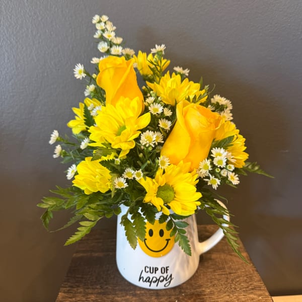 Yellow roses and daisies in a white mug with a smiley face