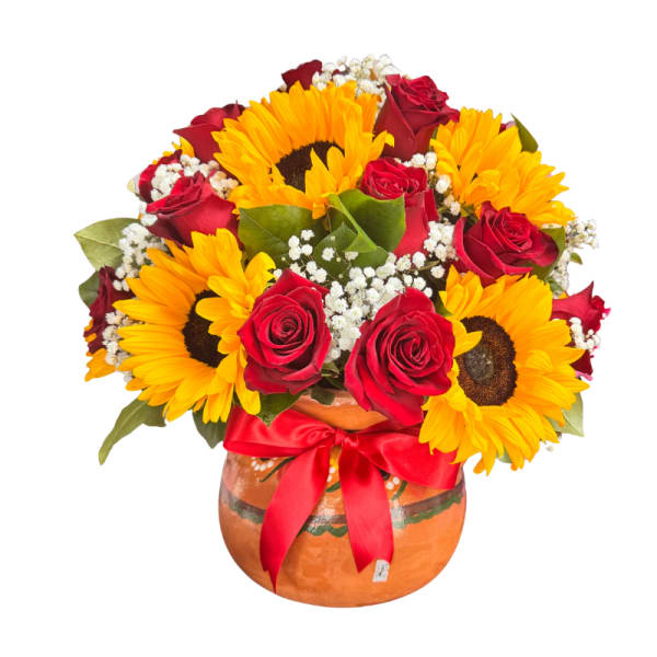 Sunflowers and red roses arranged in a round vase with a red ribbon