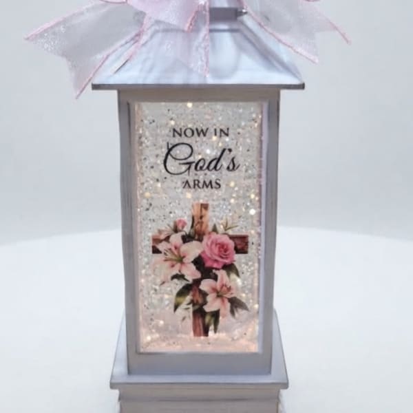 Decorative lantern with a pink bow and floral print panel