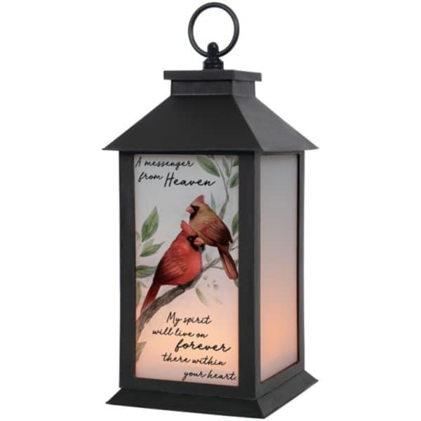 Black lantern with a cardinal memorial design and warm light inside