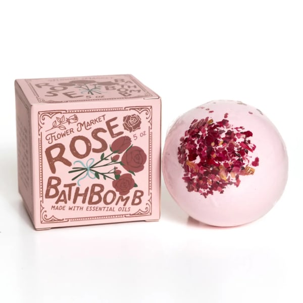 Pink rose bath bomb beside its box