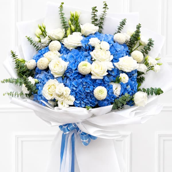 Blue hydrangea bouquet with white roses and ribbon wrap
