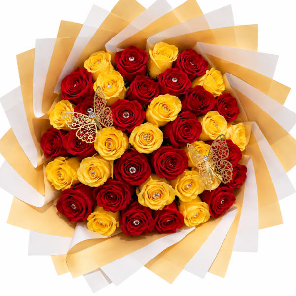 Bouquet of red and yellow roses wrapped in gold and white paper