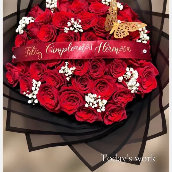 Red rose bouquet with white baby's breath and a birthday ribbon