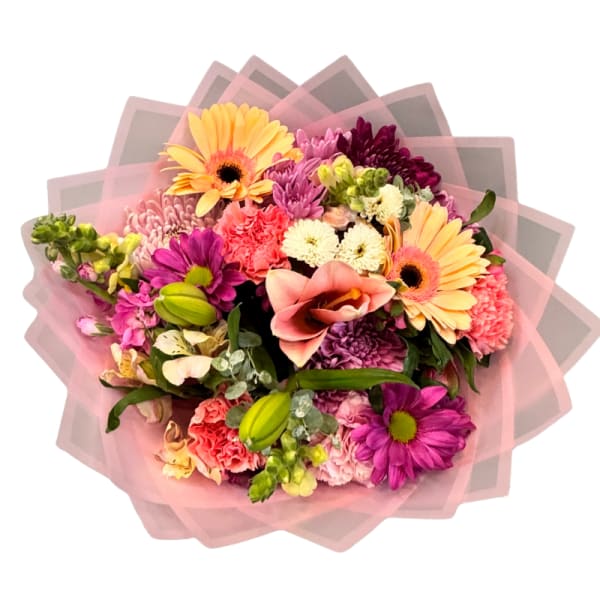 Mixed bouquet with pink, purple, and yellow flowers wrapped in pink paper