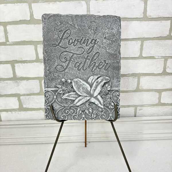 Gray memorial plaque on a metal easel with the words Loving Father