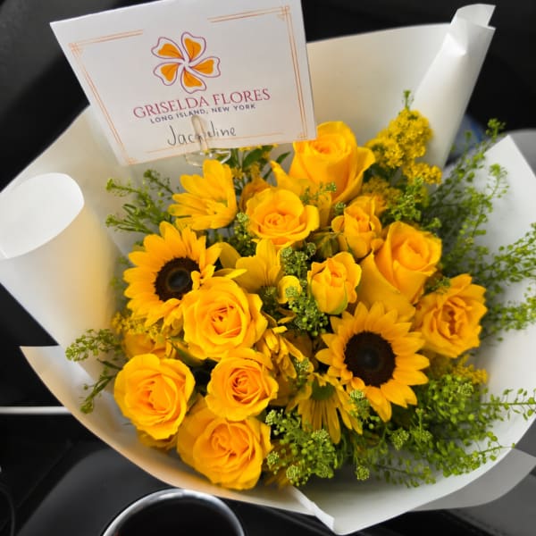 Yellow roses and sunflowers in white wrapping