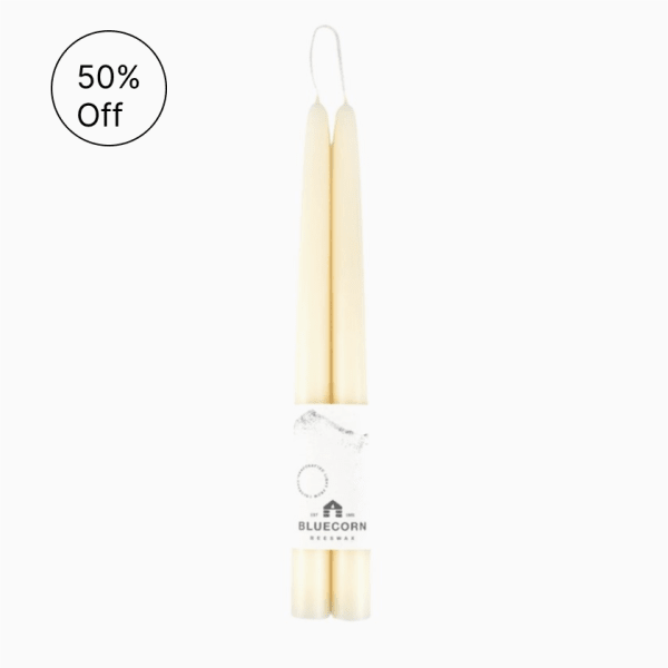 Pair of cream taper candles wrapped together with a Bluecorn Beeswax label